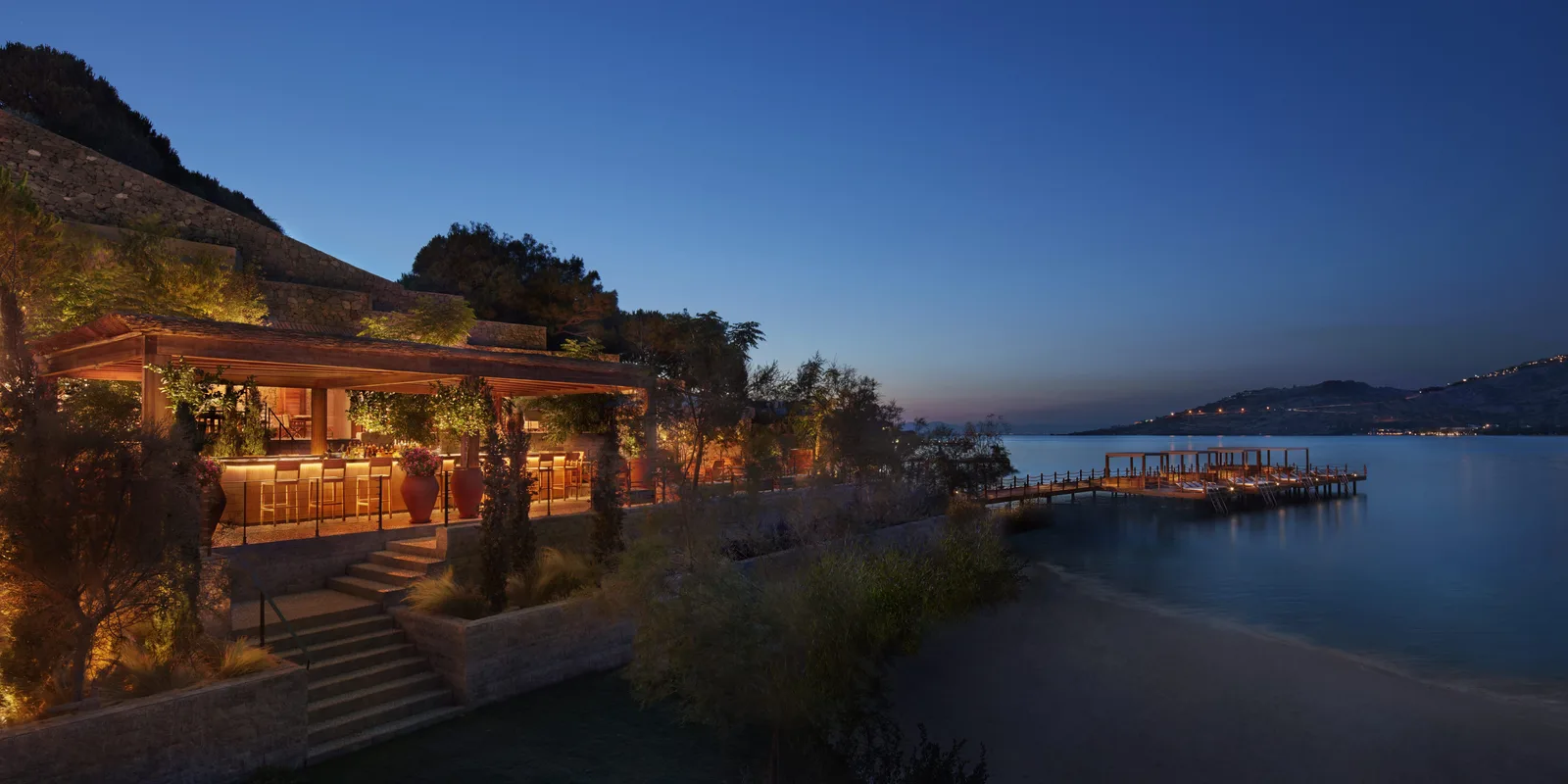 Sunset view over the infinity pool and private white sand beach of The Bodrum EDITION in Yalıkavak, Turkey.